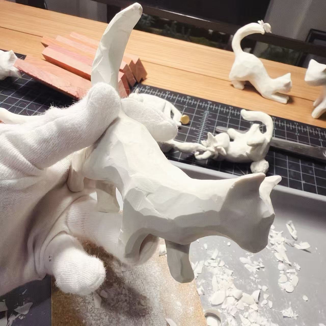 Carving a small clay figure by hand