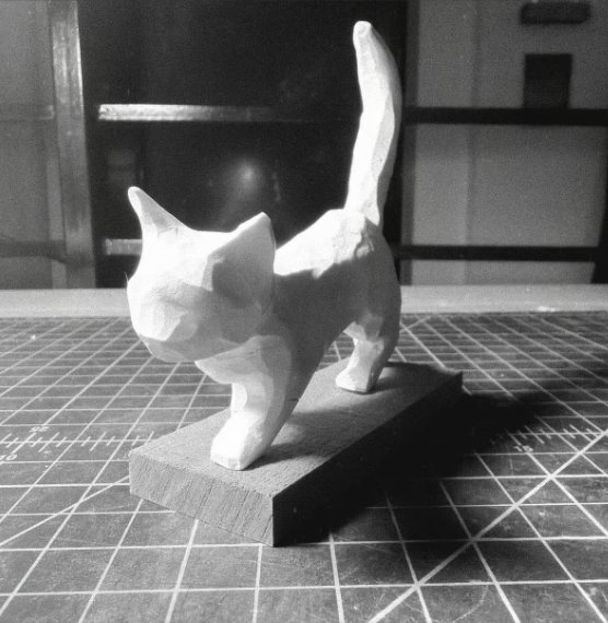 Clay cat walking with its tail up