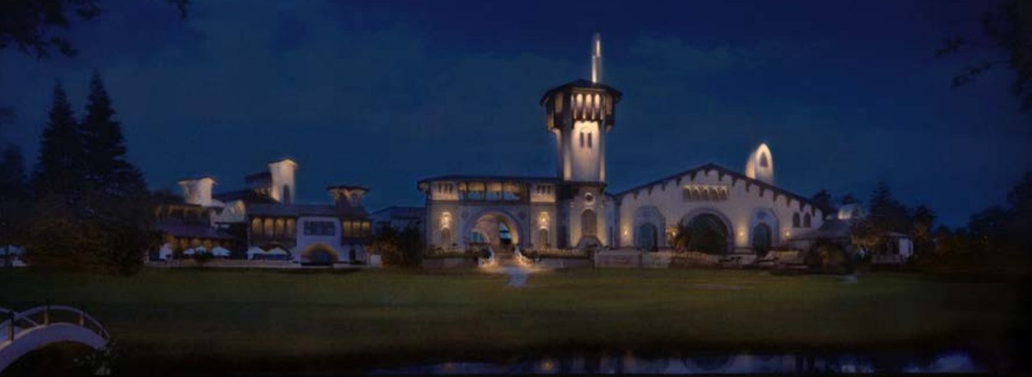 Night view of a lit villa with a tower across a lawn