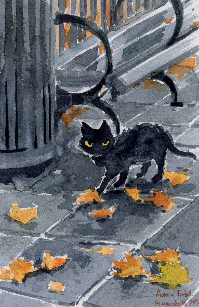 Small black cat with yellow eyes on a grey sidewalk among orange autumn leaves